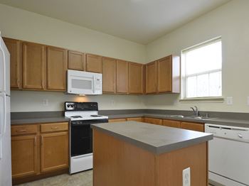 Kitchen with white appliances and wooden cabinets